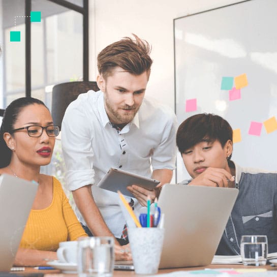 Three employees collaborating at a meeting